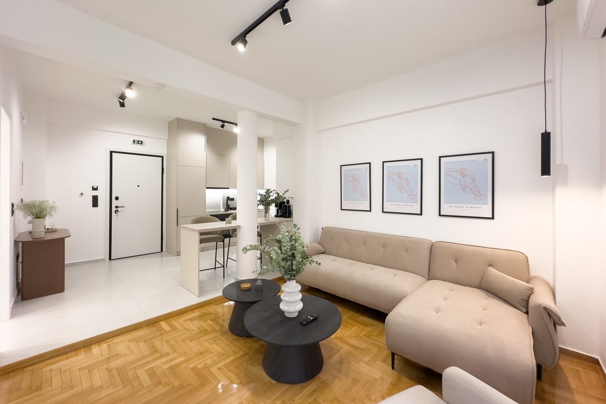 Living room with corner sofa, herringbone parquet and lobster prints