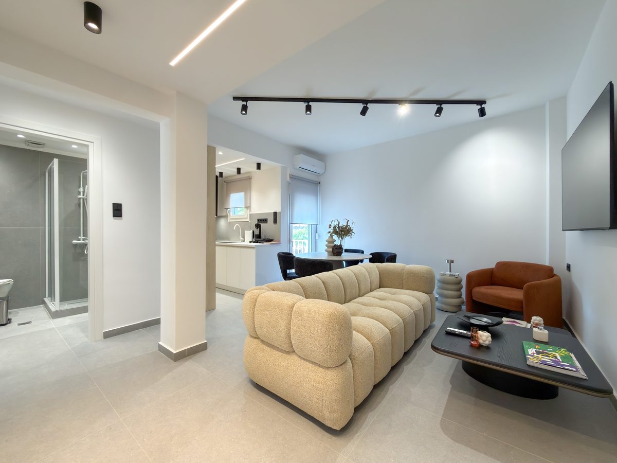 Living room with bouclé sofa and track lighting