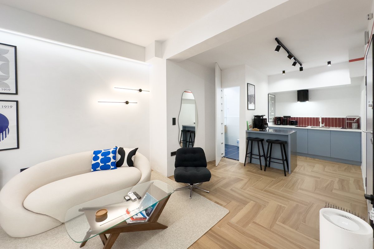 Living area with curved sofa and a view to the kitchen