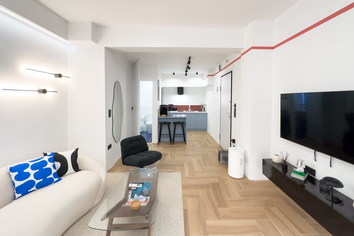Living area with TV and herringbone floor