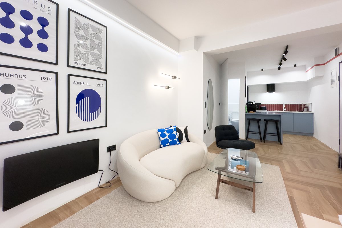 Sofa, framed prints and wall lighting