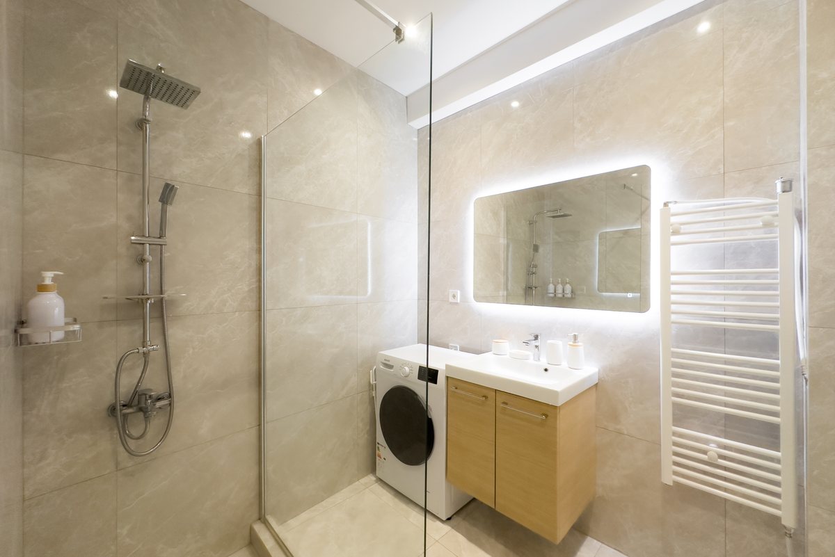 Bathroom with shower and washing machine