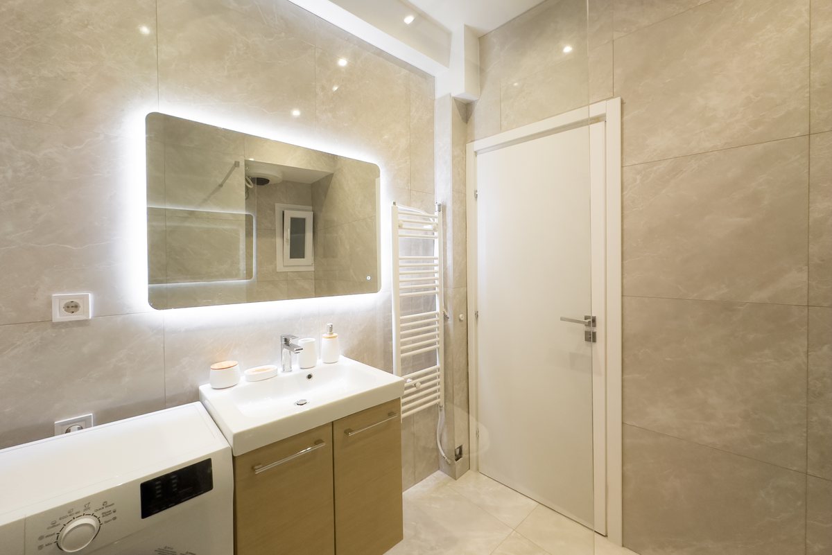 Bathroom with lit mirror